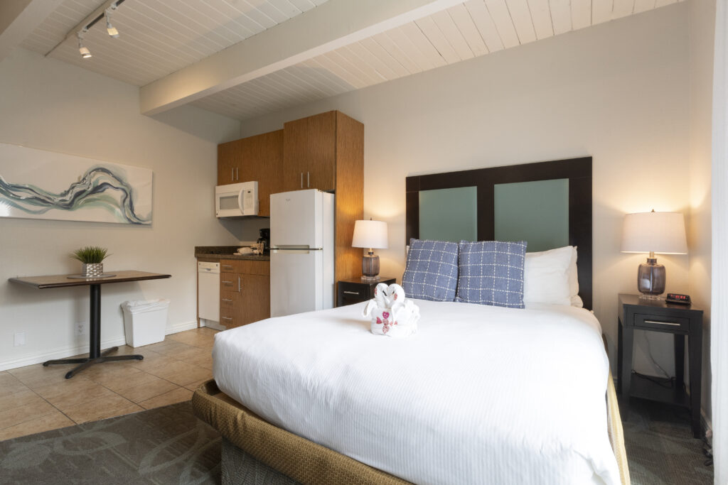 Bedroom with a bed and a refrigerator