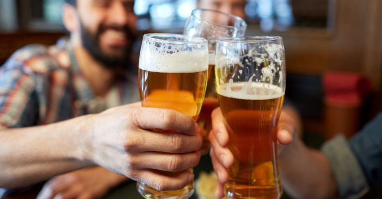 people drinking beer and cheersing
